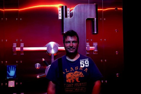 A man stands in front of a futuristic illuminated safe in the Coca-Cola Museum in Atlanta, Atlanta,