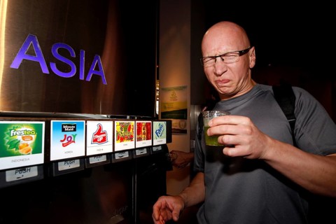 A man in the tasting room of the Coca-Cola Museum in Atlanta tastes Asian drinks with curious