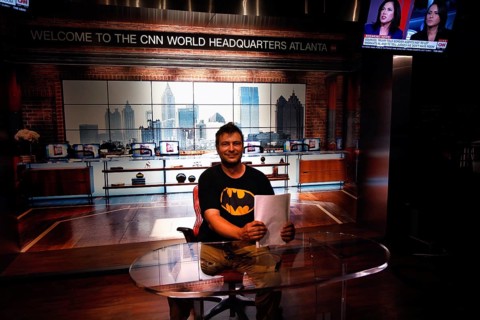 Person in the CNN studio in Atlanta in front of a news background at an anchor table, Atlanta,