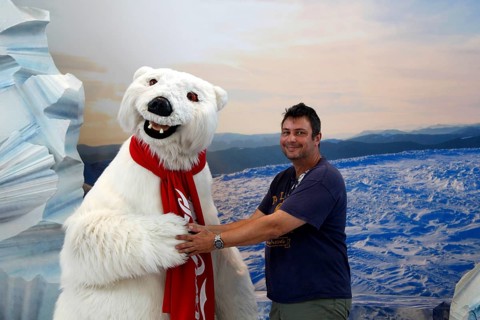Person posing with Coca-Cola polar bear at the Coca-Cola Museum, cheerful atmosphere, Atlanta,