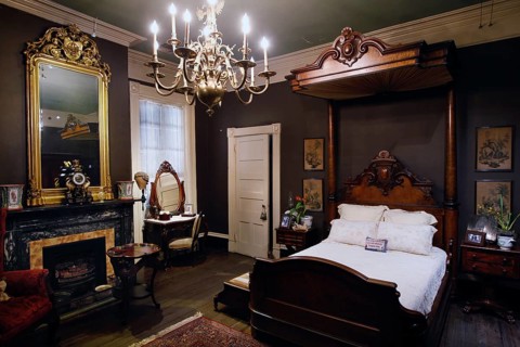 Classy bedroom with antique bed and sumptuous chandelier, zero