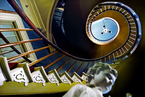 Spiral staircase with sculpture in a stylish interior, zero