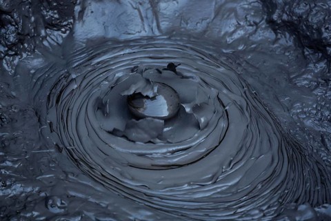 Blowing mud hole in the Whakarewarewa geothermal area in Rotorua, Rotorua, New Zealand
