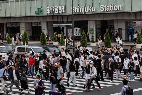 Passers-by cross the street in front of Shinjuku Station in Tokyo, Tokyo, Shinjuku, Japan