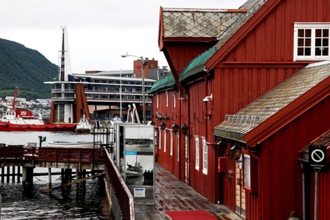 Red wooden houses by the water in Tromsø city center, Tromsø, Troms, Norway