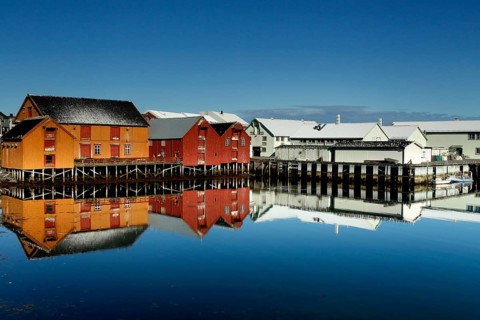 Warehouses are reflected in the calm water of the port of Vardø, Vardø, null, Norway