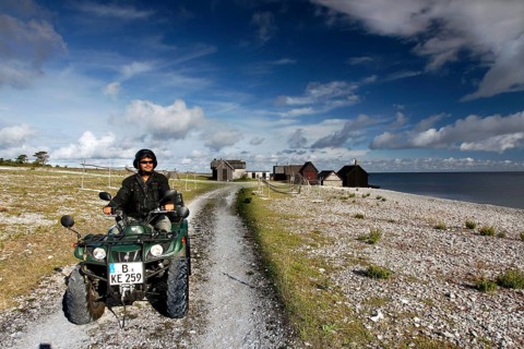 Man riding an ATV on a coastal path near Helgumannen, Helgumannen, Fårö, Sweden