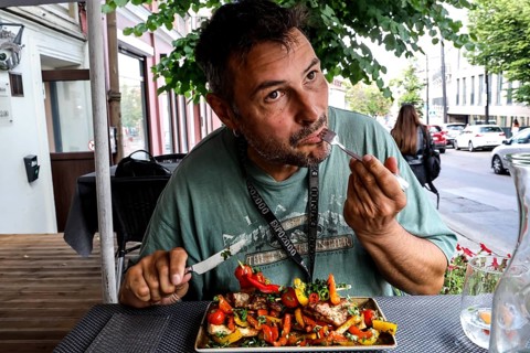 Man eats at an outdoor table at Chacapuri restaurant in Vilnius, Vilnius, Vilnius County, Lithuania