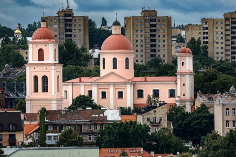 Church with red domes in front of modern residential buildings in Vilnius, Vilnius, Lithuania