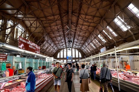 Interior view of bustling central market with historic structures, Riga, Latvia