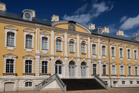 Ruhenthal Castle with classic baroque façade under bright blue sky, Rundale, Latvia