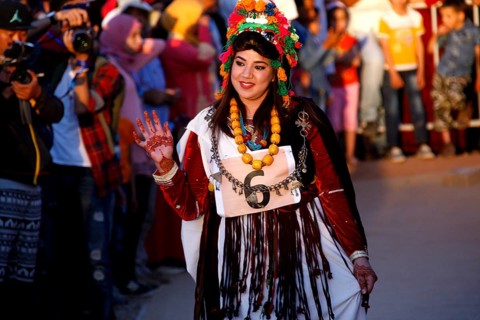 Woman in festive dress parading during the Fête des Roses, El Kelâa m'Gouna, Marrakesh-Safi,
