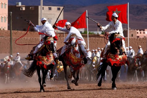 Riders in traditional clothing perform at Fantasia during the Fête des Roses, El Kelâa m'Gouna,