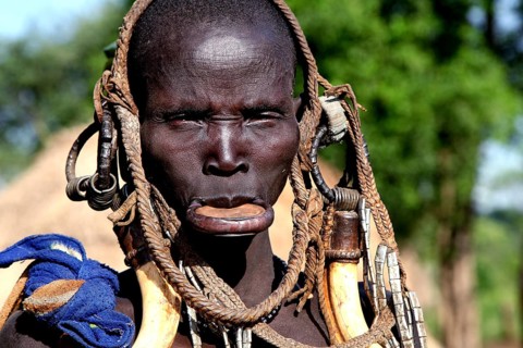 Mursi woman with a large lip plate and traditional clothes in Mago National Park, Mago National