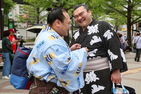 Two sumo wrestlers joke at an event in Tokyo, Tokyo, Ryogoku, Japan