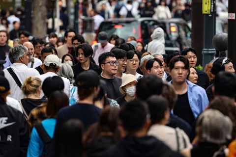 Crowded street scene with many passers-by on Dogen-zaka Street, Tokyo, Japan
