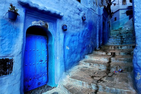 Narrow, blue street with Moroccan-decorated doors and a staircase in Chefchaouen, Chefchaouen,