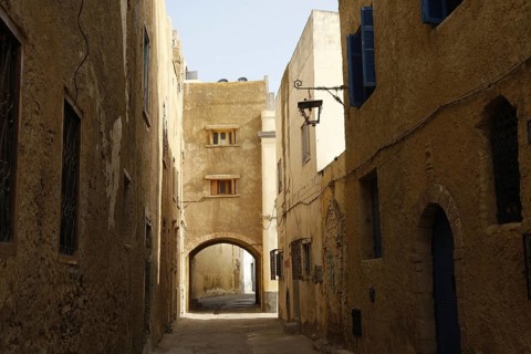 Shady alley with stone buildings and arched passageway, El Jadida, Cité Portugaise, Morocco