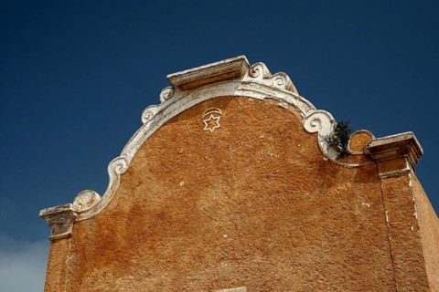 Detailed façade of a historic structure under clear sky, El Jadida, Cité Portugaise, Morocco