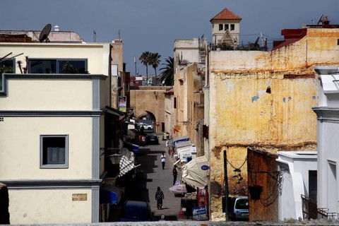 Narrow street through old walls and buildings under sunny sky, El Jadida, Cité Portugaise, Morocco