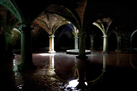 Dark cistern with gothic arches and reflecting water surfaces in El Jadida, El Jadida,