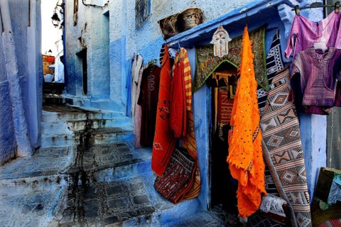 Picturesque blue road in the medina of Chefchaouen with colorful textiles, Chefchaouen, zero,