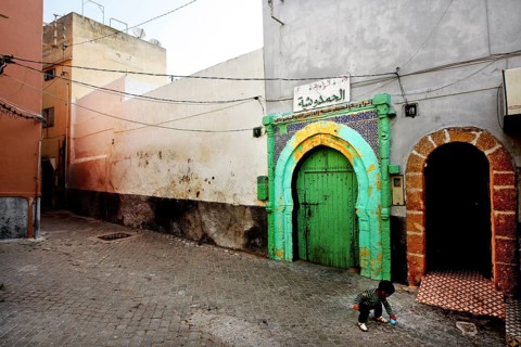 A quiet alley with colorful gates and historic buildings in an abandoned atmosphere, El Jadida,