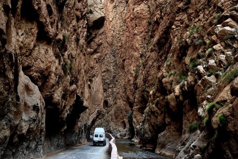 A white vehicle drives through the narrow section of Dadès Gorge, Dadès Gorge, Morocco