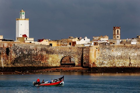 Historic seaside fortress with a small boat in the foreground, El Jadida, Cité Portugaise, Morocco
