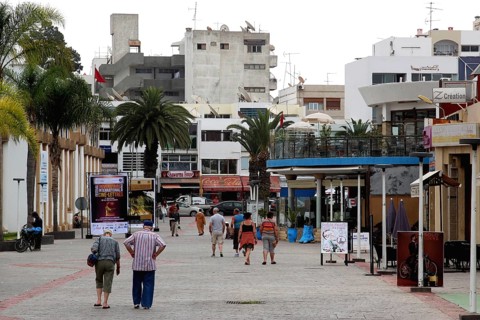 Passers-by stroll through Agadir's pedestrian zone under palm trees, Agadir, Souss, Morocco