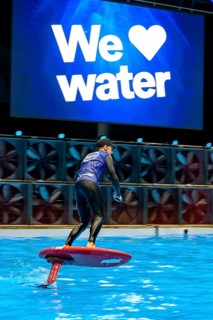Press photo dynamic photo of eFoil surfer in the large XXL pool in Hall 17 of Messe Boot