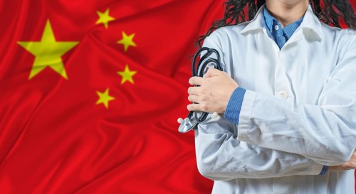 Healthcare professional with China flag background. Professional doctor holding stethoscope on