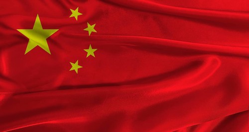 Flag of China with fabric textured background. Close up of National flag of China with realistic