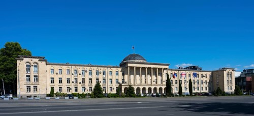 Extensive classical building in panoramic view under bright blue sky, City Hall, Gori, Inner Kartli