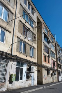 Multi-storey apartment unit with visible cables and worn exterior façade, Gori, Inner Kartli