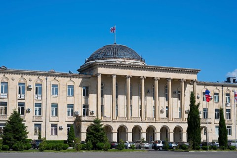 Impressive classic building with dome and pillars under a clear blue sky, City Hall, Gori,
