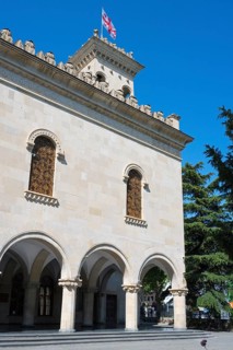 Historic building with decorated façade and a flag against a blue sky, Josef Stalin Museum, Gori,
