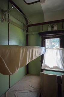 Interior of a historic train compartment with beds and curtains on the windows, Stalin's personal