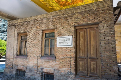 Brick wall of a building with wooden doors and windows, rustic appearance, birthplace of Josef