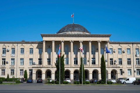 View of classic building with dome and flags surrounded by cypresses, City Hall, Gori, Inner Kartli