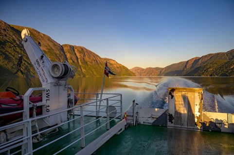 Ferry trip on Lysefjord at sunrise with mountains and waves in the background, Lysefjord, Rogaland,
