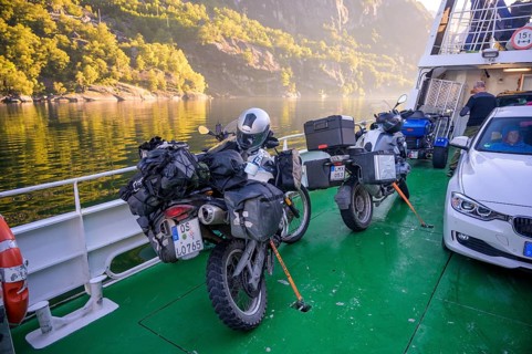 Motorbikes with luggage on a Kolumbsu shipping company ferry on the Lysefjord in sunny weather,