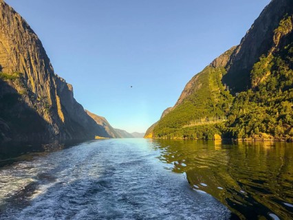 Lysebotn, Rogaland Municipality, Norway, Lysejord with calm water surrounded by steep, sunlit