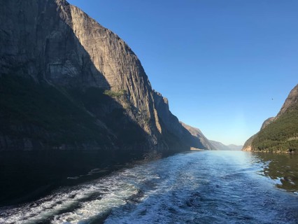 Lysebotn, Rogaland Municipality, Norway, view of the trail of a boat in the quiet Lysefjord between