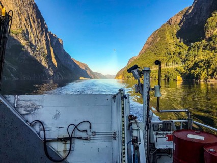 Lysebotn, Rogaland Municipality, Norway, View from a boat of the sunny Lysefjord surrounded by high