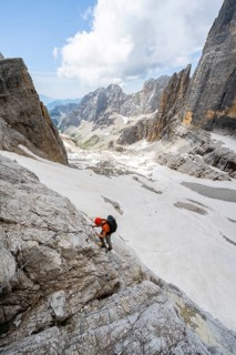 Mountaineer climbs on a steep rock face in the Via Ferrata Brentari via ferrata, spectacular