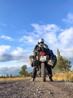 Idre, Dalarnas län, Sweden, BMW G 650 GS Sertao enduro motorcyclist posing on a gravel road under a