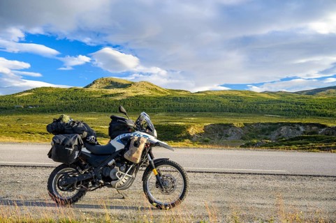 Dalholen, Innlandet, Norway, BMW G 650 GS Sertao enduro motorcycle along a road through green hills