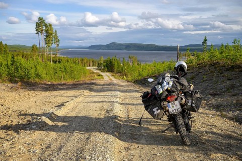 Lövdalen, Jämtland County, Sweden, A dirt road leads through slightly wooded terrain with a BMW G
