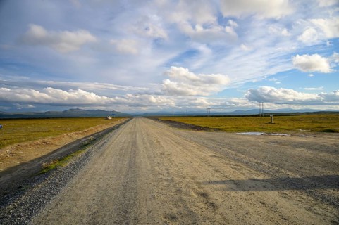 Falkvålen, Bruksvallarna, Jämtland, Sweden, long straight road in a wide landscape under a gently